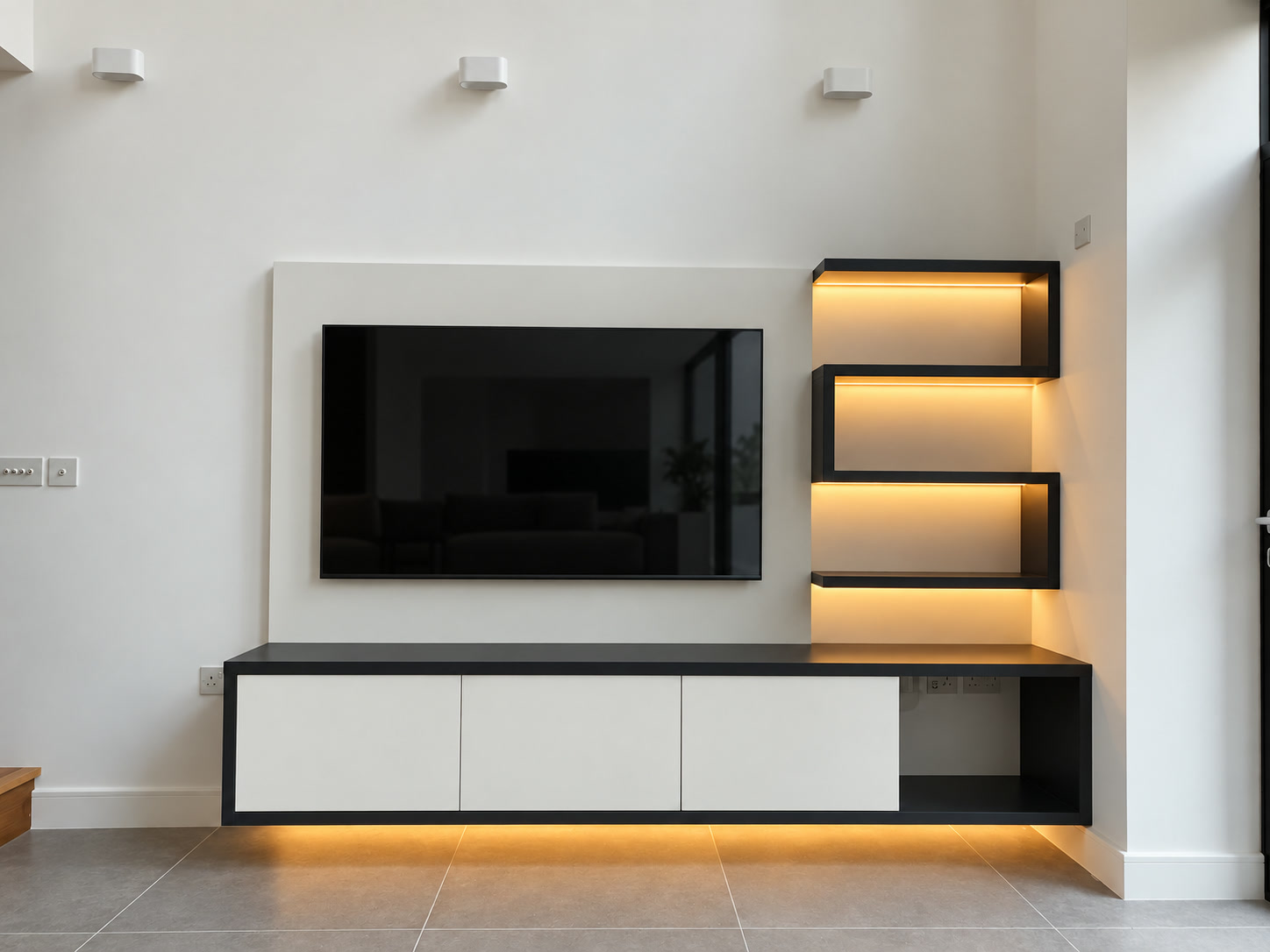 Frontal view of a bespoke TV media wall with asymmetric warm LED display shelves