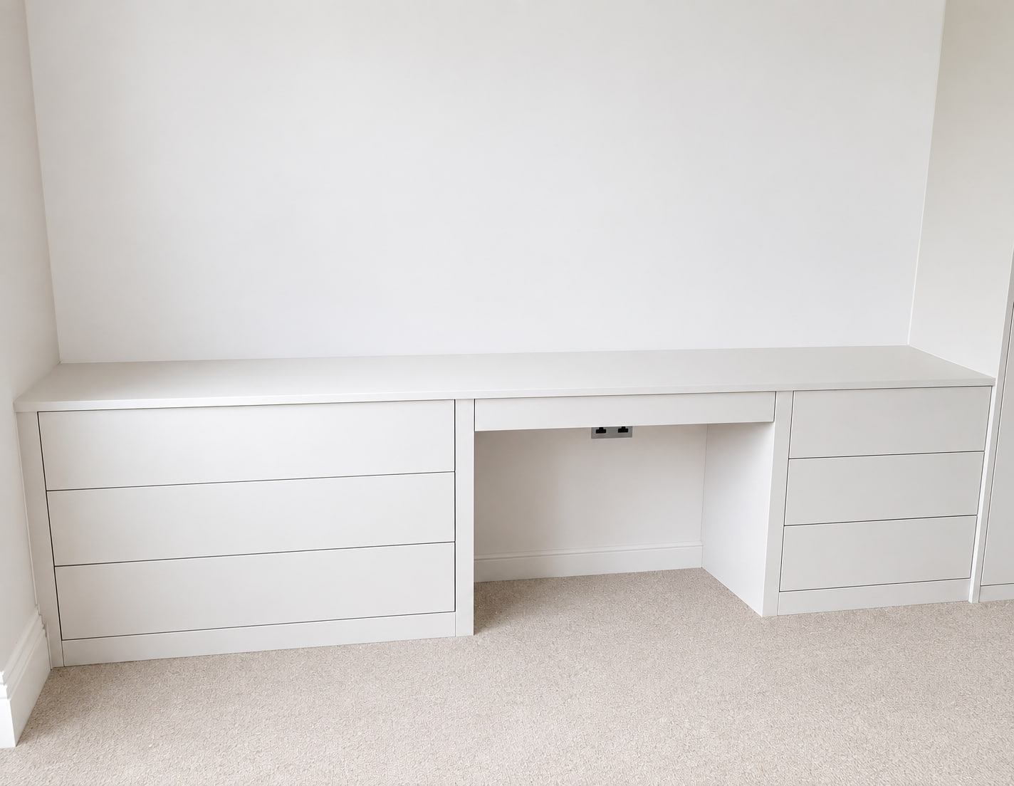 Wall-to-wall fitted study desk with drawer storage
