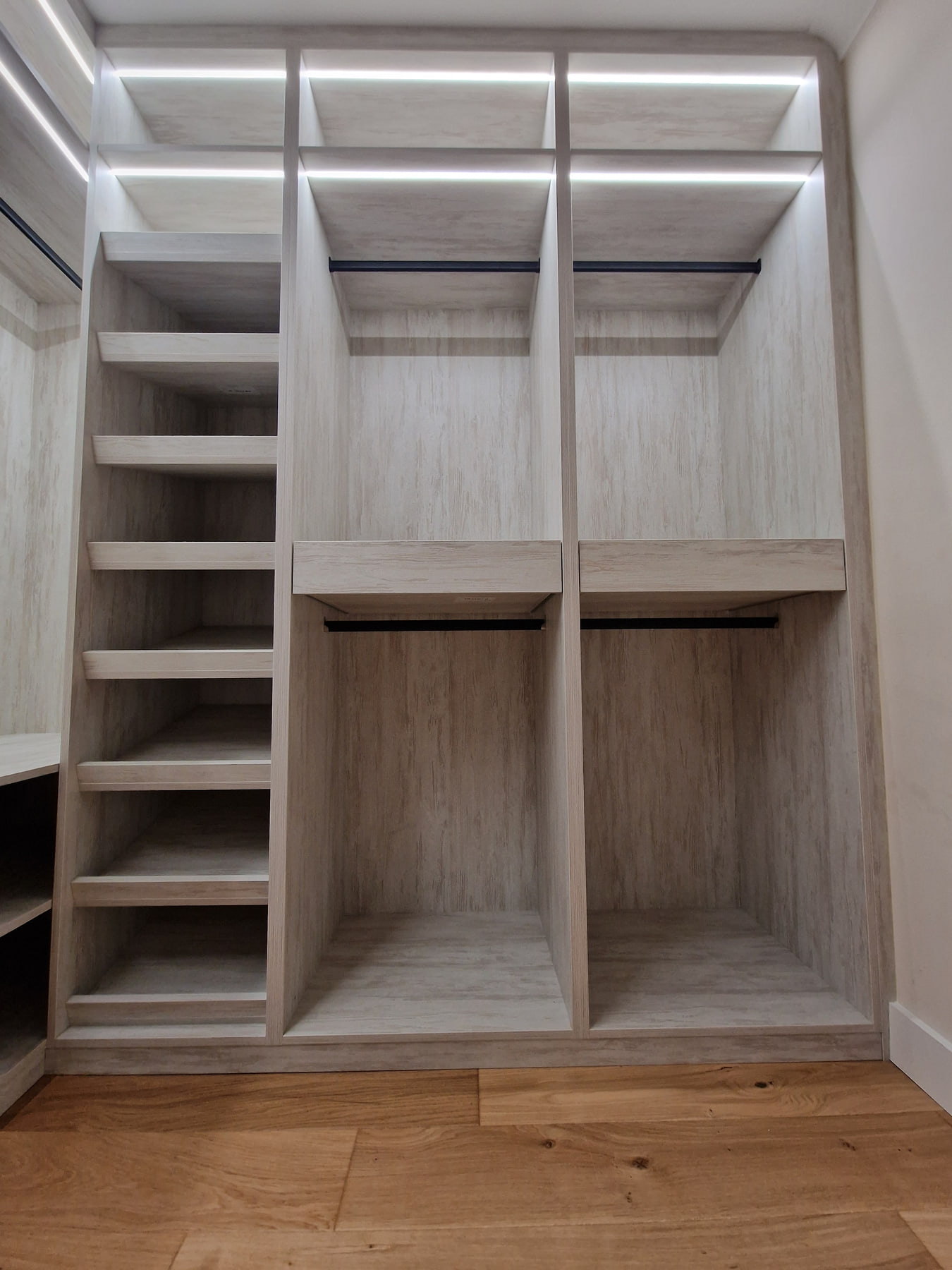 Integrated LED lighting above shelving and hanging rails